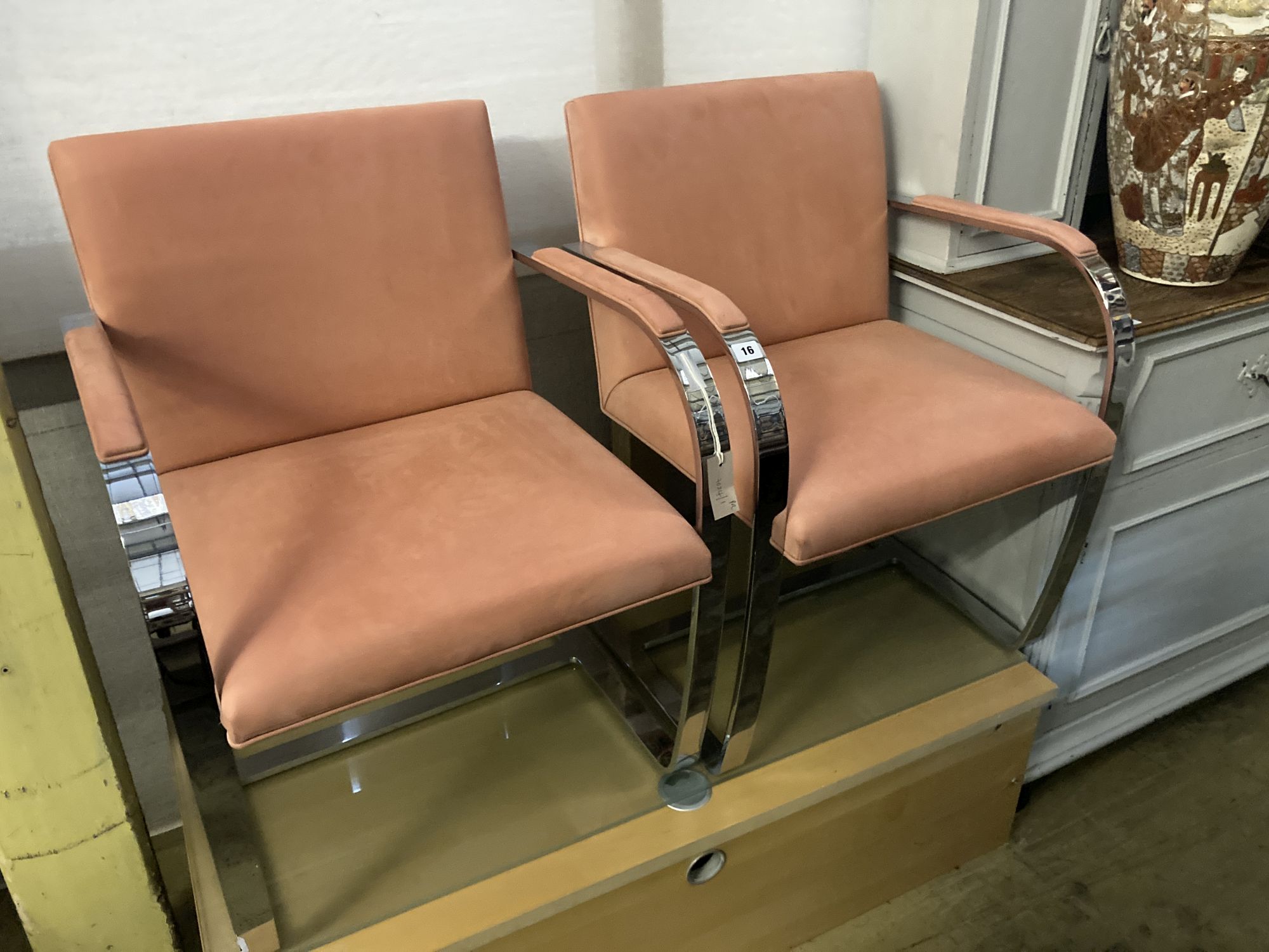 A pair of Knoll International BRNO chairs, after Mies Van De Rohe, upholstered in peach suede fabric, width 58cm depth 54cm height 79cm